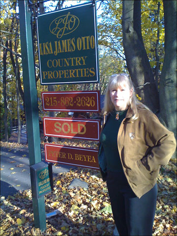 A photo of Nancy Birnes in front of our house's Sold sign. A photo of Nancy Birnes in front of our house's Sold sign.